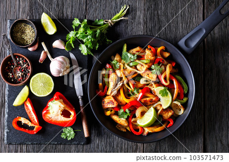 chicken fajitas with bell peppers, onion, spices 103571473