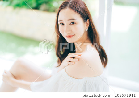young woman wearing off-the-shoulder 103571911