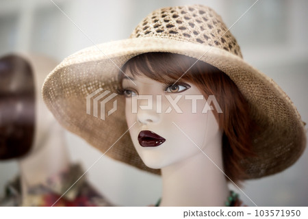 Closeup of summer hat on the head of mannequin in a fashion store showroom Closeup of summer hat on the head of mannequin in a fashion store showroom 103571950