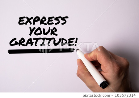 Express your gratitude. Male hand holding a black marker on a white background Express your gratitude. Male hand holding a black marker on a white background 103572314