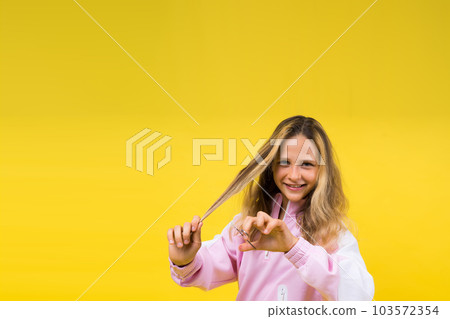 Cheerful kid cut long hair, casual fashion style for beautiful child, girl use hairdresser scissors. Cheerful kid cut long hair, casual fashion style for beautiful child, girl use hairdresser scissors. 103572354