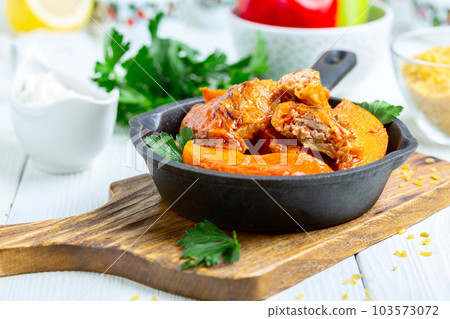 Stuffed cabbage rolls with meat and bulgur in tomato sauce. 103573072