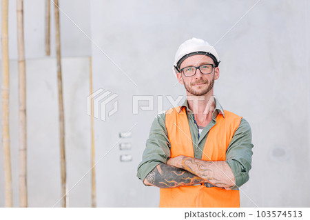 portrait hipster worker cosntruction engineer architect . builder foreman work in construction site smart arm crossed confident smile. 103574513