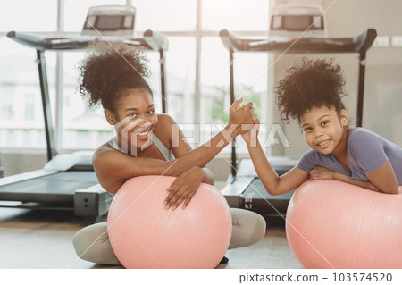 happy sport fitness healthy woman with child smiling in sport club treadmill background 103574520