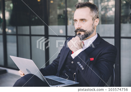Business man Hispanic Latin Indian Adult Male Mustache and Beard Smart Thinking with Laptop sitting outdoors Business man Hispanic Latin Indian Adult Male Mustache and Beard Smart Thinking with Laptop sitting outdoors 103574756