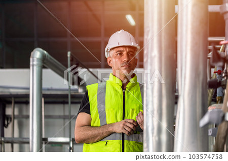 Factory engineer male worker checking high pressure pipe guage in factory boiler room Factory engineer male worker checking high pressure pipe guage in factory boiler room 103574758