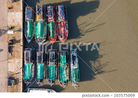 Aerial view of fishing boats moored at marina 103575009
