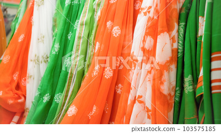 Natural Indian fabrics in bright colors orange, white, green for tailoring traditional festive clothes. Concept Independence Day 103575185