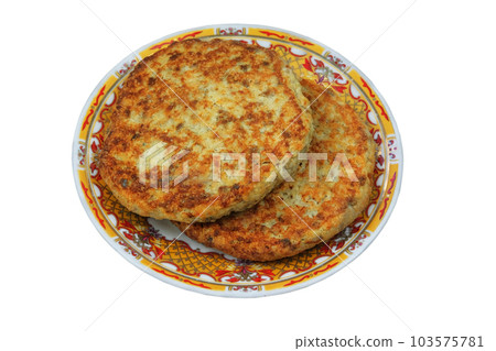 Cutlets on a plate isolated on white background. Homemade meatballs. Portion of sliced meat breaded and served either grilled or fried. 103575781