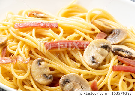 Close-up of salami sausage and mushroom pasta (spaghetti). Close-up of salami sausage and mushroom pasta (spaghetti). 103576383