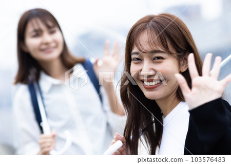 A woman going home on a rainy day 103576483