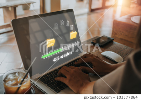 Transfer files data system relocation concept, Person hand using laptop computer waiting for transfer file process with loading bar icon on virtual screen. 103577864
