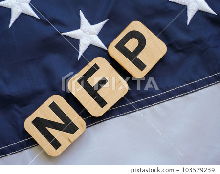 Cubes with the letters NFP Nonfarm Payrolls lie on the flag of the USA. Cubes with the letters NFP Nonfarm Payrolls lie on the flag of the USA. 103579239