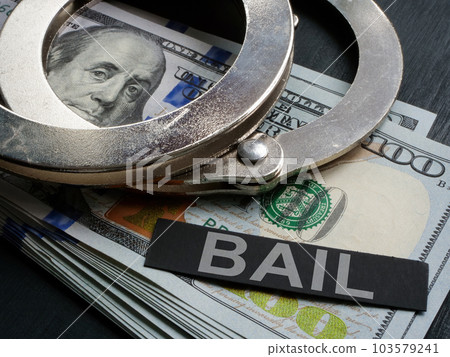 Handcuffs lie on cash and next to it is the inscription bail. Handcuffs lie on cash and next to it is the inscription bail. 103579241