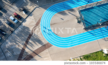 Blue running track on public sports ground aerial view Blue running track on public sports ground aerial view 103580874