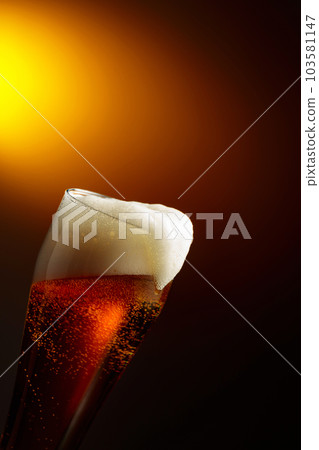 Beer in a tall glass. 103581147