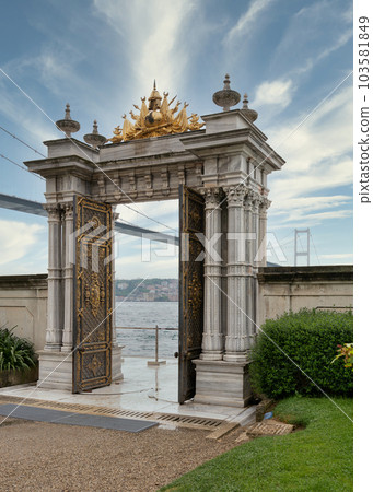 Marble gate with decorated door leading to sea, with Bosphorus Bridge in the background, Beylerbeyi Palace, Istanbul 103581849