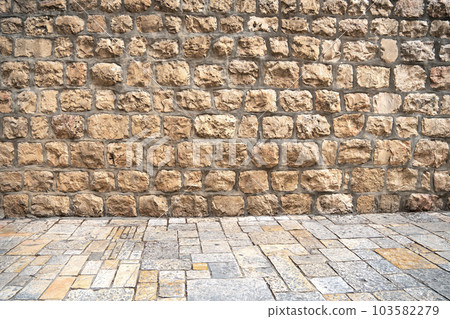 Ancient brick wall and pavement of old city of Jerusalem, Israel Ancient brick wall and pavement of old city of Jerusalem, Israel 103582279