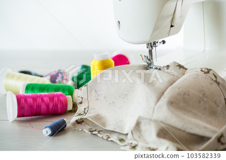 Sewing machine with fabric and threads for sewing, close-up. The working process 103582339