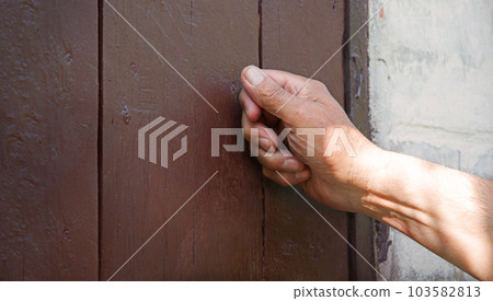 Man's hand knocking on the door Man's hand knocking on the door 103582813