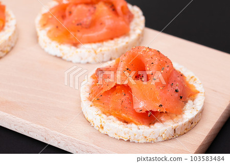 Tasty Rice Cake Sandwiches with Fresh Salmon Slices 103583484