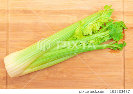 Fresh Celery Stem on Wooden Cutting Board Fresh Celery Stem on Wooden Cutting Board 103583487