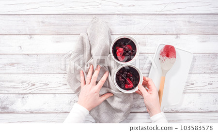 Step by step. Serving homemade mix berry compote in small white bowls on a wooden table. Step by step. Serving homemade mix berry compote in small white bowls on a wooden table. 103583578