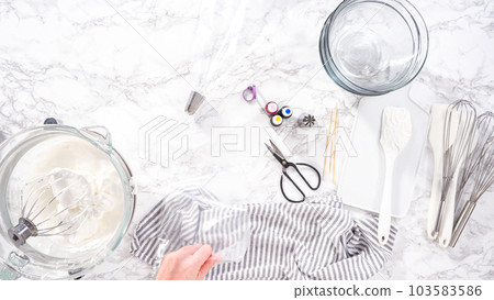 Step by step. Flat lay. Mixing food coloring into the meringue to bake unicorn meringue cookies. Step by step. Flat lay. Mixing food coloring into the meringue to bake unicorn meringue cookies. 103583586