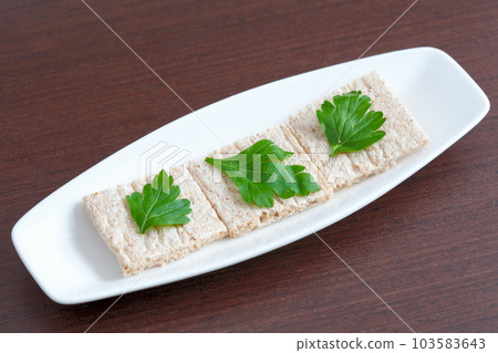 Diet bread with parsley on a plate 103583643