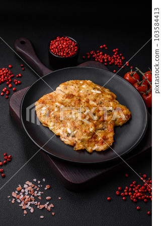 Delicious fried chicken breast in batter with mustard, salt, spices and cheese 103584413