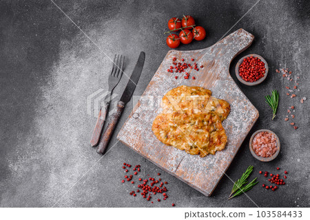 Delicious fried chicken breast in batter with mustard, salt, spices and cheese 103584433