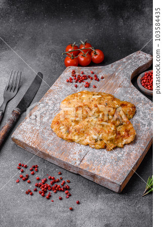 Delicious fried chicken breast in batter with mustard, salt, spices and cheese 103584435