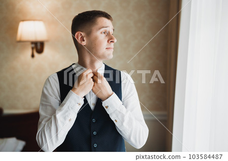 Beautiful man, groom posing and preparing for wedding 103584487