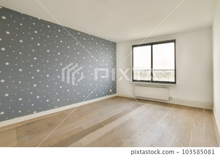 an empty room with stars painted on the wall and hardwood flooring in front of the window looking out to the city an empty room with stars painted on the wall and hardwood flooring in front of the window looking out to the city 103585081