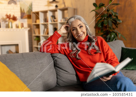 Contented pretty senior woman with a book Contented pretty senior woman with a book 103585431