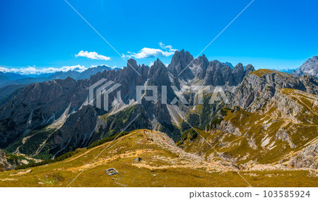 Majestic Rocky Peaks Embraced by Blue Sky and White Clouds near the Three Peaks of Lavaredo Majestic Rocky Peaks Embraced by Blue Sky and White Clouds near the Three Peaks of Lavaredo 103585924