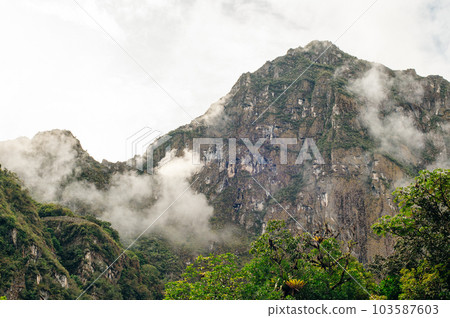 Morning Clouds surround the mountains near Machu Picchu  103587603