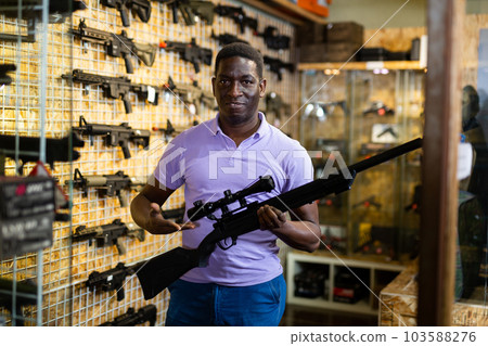 African-american man in weapon shop African-american man in weapon shop 103588276