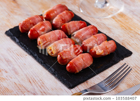 Spanish tasty meal rolled in bacon sausages Spanish tasty meal rolled in bacon sausages 103588407