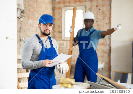 Foreman is dissatisfied with the work performed by the worker at construction site Foreman is dissatisfied with the work performed by the worker at construction site 103588560