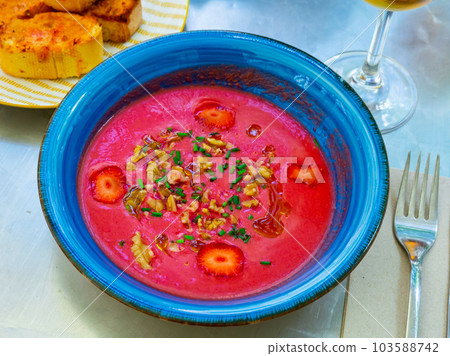 Beetroot salmorejo with walnuts and strawberry 103588742