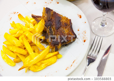 Tasty beef steak with french fries served at plate, spanish dish 103588803