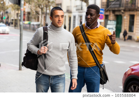 Two men going through town streets 103588804