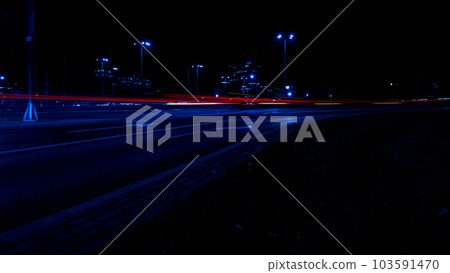 Lights of cars at night. Street line lights. Night highway city. Long exposure photograph night road. Colored bands of red light trails on the road. Background wallpaper defocused Lights of cars at night. Street line lights. Night highway city. Long exposure photograph night road. Colored bands of red light trails on the road. Background wallpaper defocused 103591470