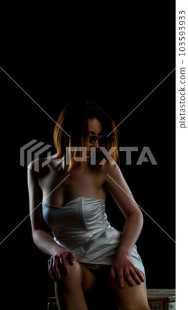 woman in white dress on red chair woman in white dress on red chair 103593933
