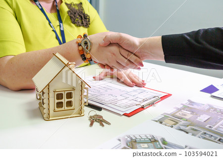 Real estate agent shaking hands after signing a contract document for the purchase of real estate in the office by the client, business concept and signing the contract Real estate agent shaking hands after signing a contract document for the purchase of real estate in the office by the client, business concept and signing the contract 103594021