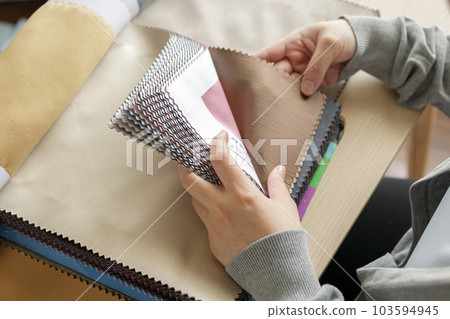 female designer with fabric color samples choosing textile for curtains female designer with fabric color samples choosing textile for curtains 103594945