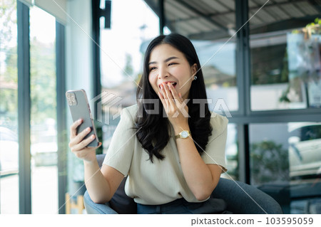 Video call. Young Asian woman communicating on long-distance online video. looking digital smartphone screen Happy talking with friends happily Video call. Young Asian woman communicating on long-distance online video. looking digital smartphone screen Happy talking with friends happily 103595059