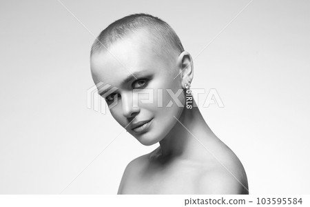black and white portrait of bald girl with stylish jewelry earrings black and white portrait of bald girl with stylish jewelry earrings 103595584