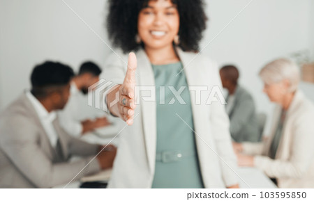 Giving you a warm welcome. Shot of a young businesswoman extending her hand out for a handshake at work. 103595850
